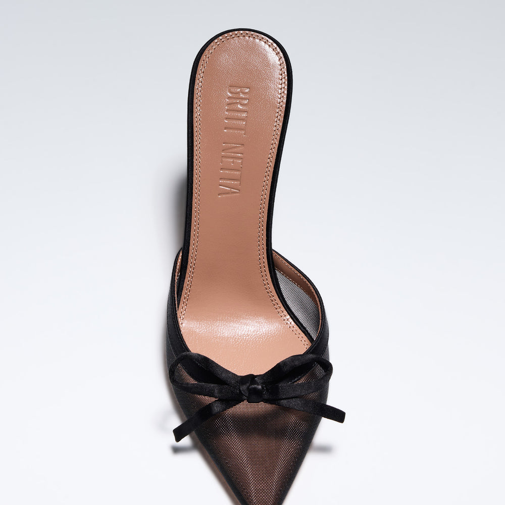 
                      
                        Hand-crafted in Italy, the Amelia (“Amelia”) mule features a glossy black satin and is set upon our custom 95mm heel designed for your comfort. Amelia is accented with our signature mesh upper that gently molds to your foot and features an elegant satin bow making it the perfect addition to your wardrobe this holiday season.
                      
                    