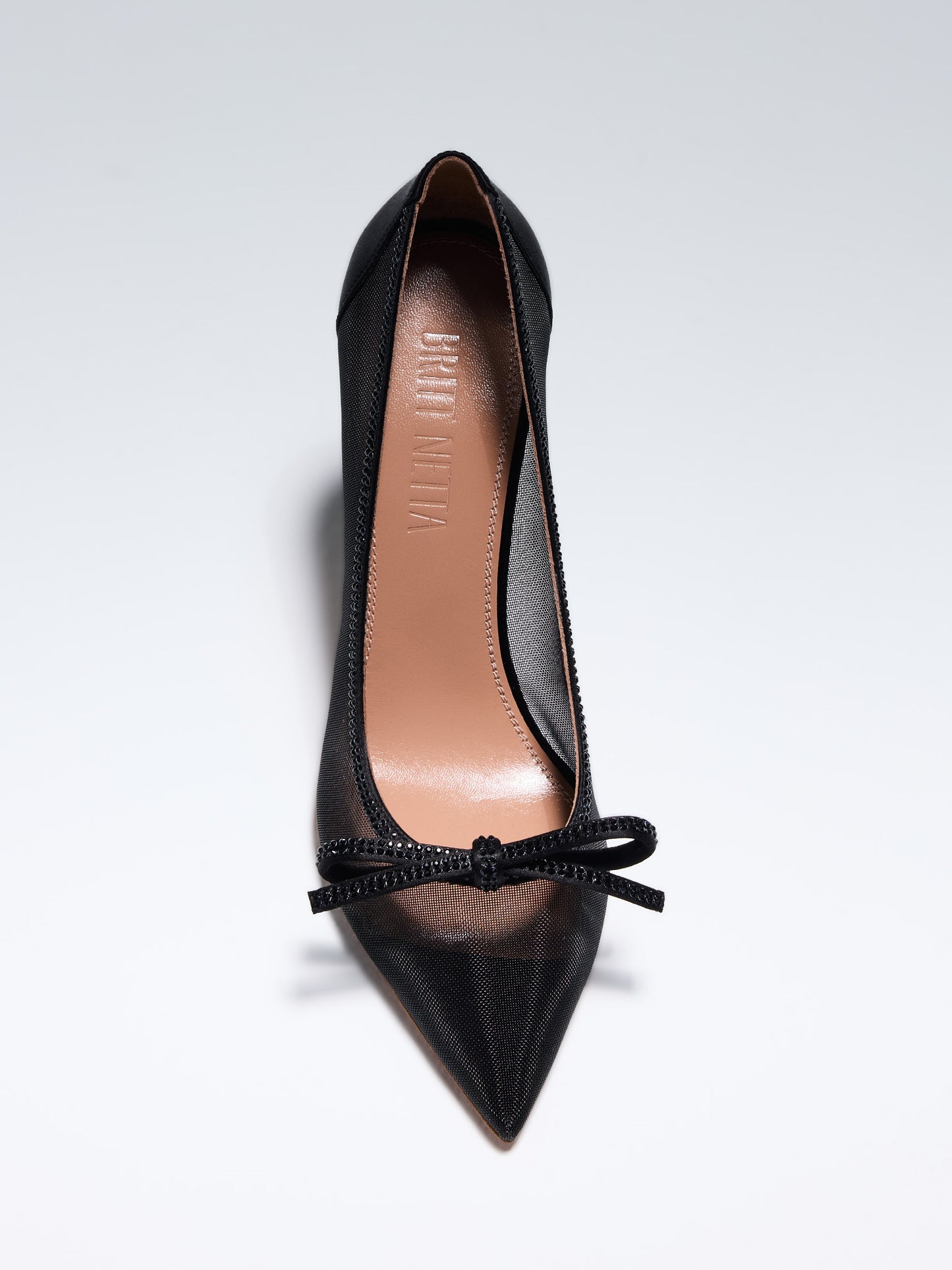 
                  
                    Hand-crafted in Italy, the Cinderella (“Cinderella”) pump features a glossy black satin and is set upon our custom 95mm heel designed for your comfort. Cinderella is accented with our signature mesh upper that gently molds to your foot and features a bold bow that is embellished with glittering Swarovski crystals.
                  
                